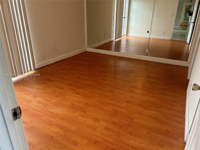 unfurnished bedroom with hardwood / wood-style floors and a closet