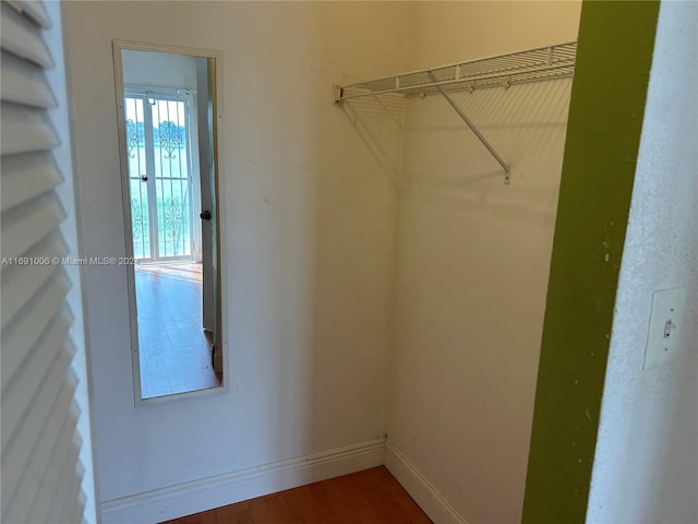 walk in closet featuring dark wood-type flooring