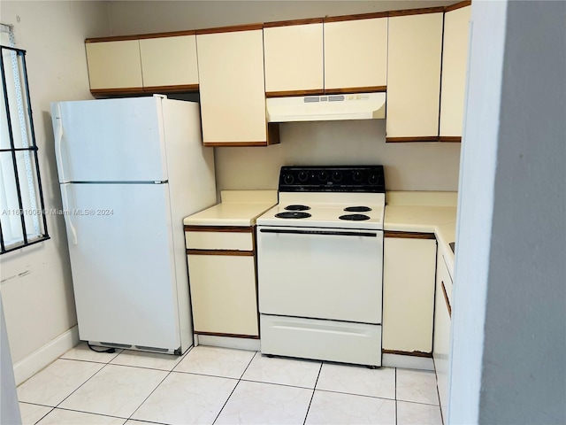 kitchen featuring white cabinetry, light tile patterned flooring, and white appliances