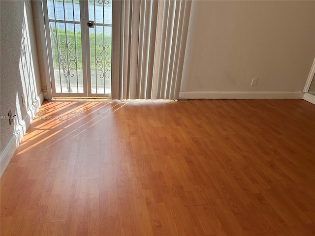 empty room featuring light hardwood / wood-style flooring and a water view