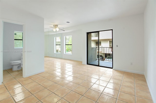 spare room featuring ceiling fan and light tile patterned flooring