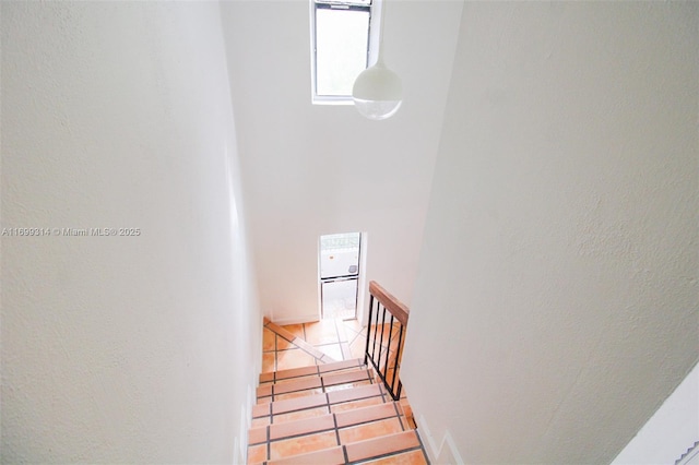 staircase with tile patterned floors