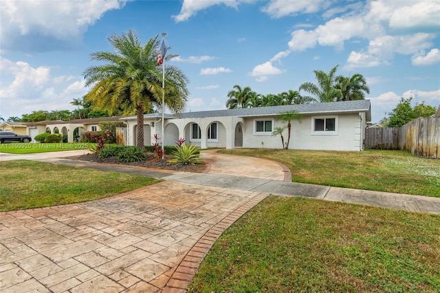 single story home with a front lawn