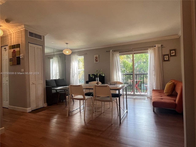 dining room featuring dark hardwood / wood-style floors and ornamental molding