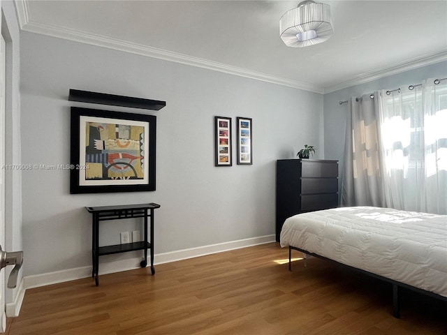 bedroom featuring wood-type flooring and ornamental molding