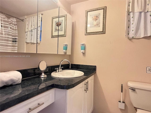 bathroom featuring vanity and toilet