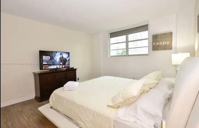 bedroom with hardwood / wood-style floors