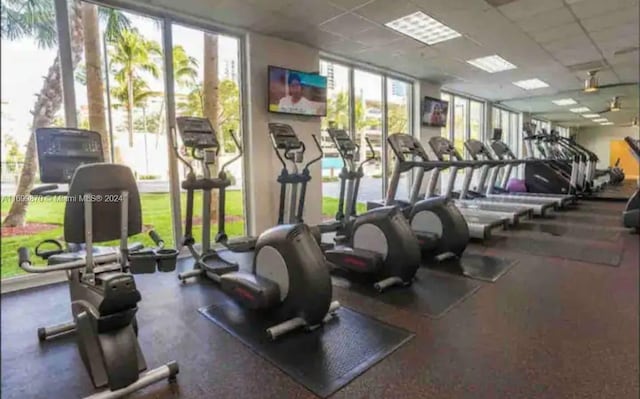 gym with a paneled ceiling