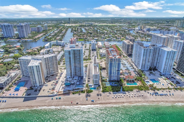 drone / aerial view featuring a water view and a beach view