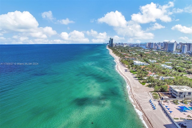 drone / aerial view featuring a water view and a beach view