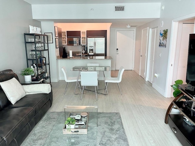 living room featuring wood-type flooring and sink