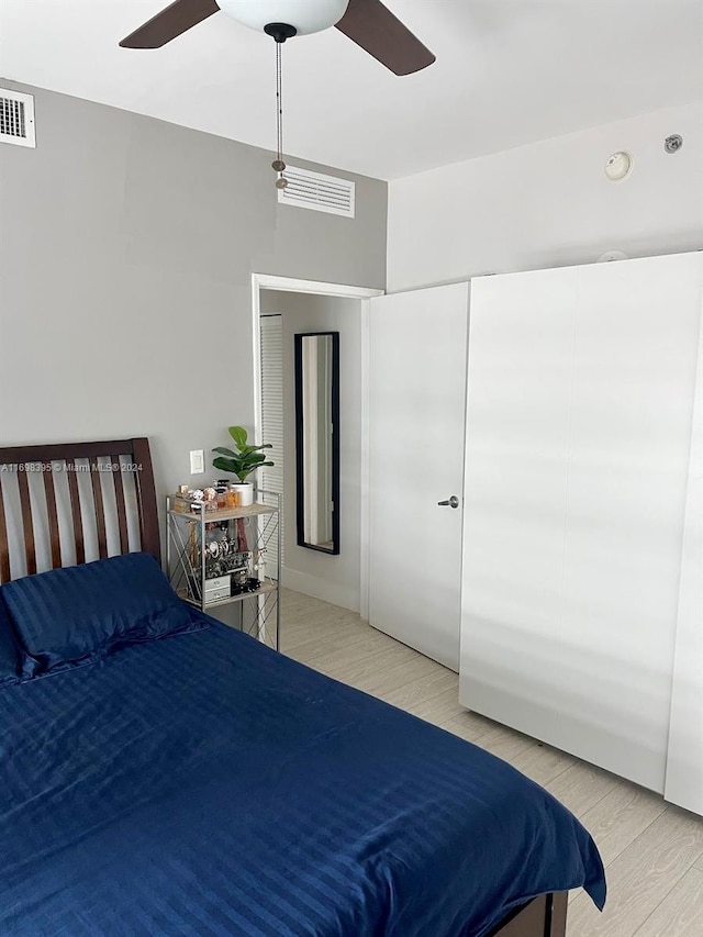 bedroom with light wood-type flooring and ceiling fan