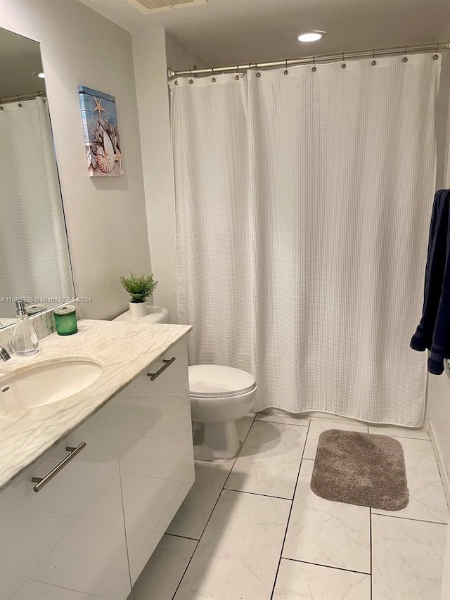 bathroom featuring vanity and toilet