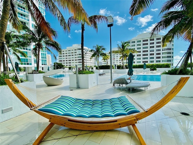 view of community featuring a pool and a patio area