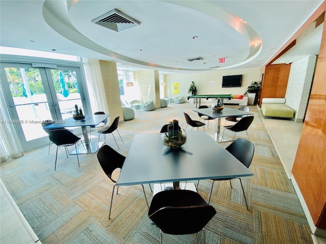 interior space featuring french doors and a tray ceiling