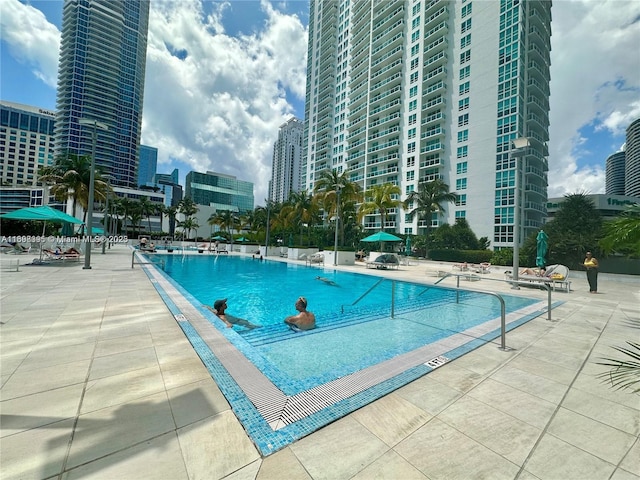 950 Brickell Bay Dr Unit 802, Miami, FL 33131 - community pool featuring a patio area and a city view