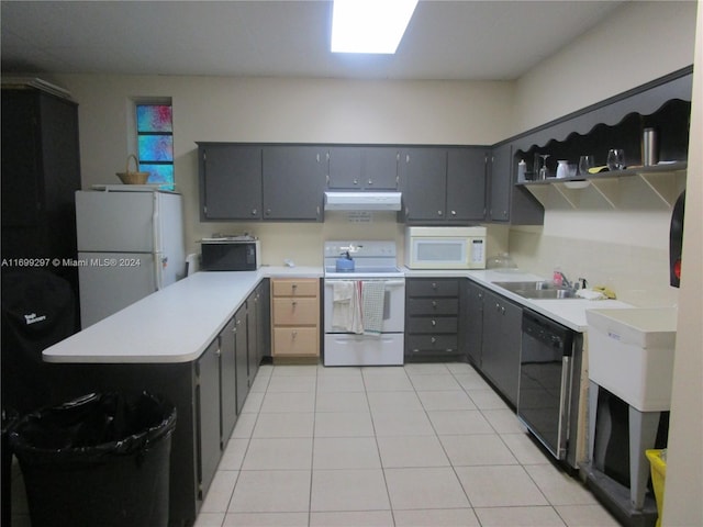 kitchen featuring gray cabinetry, sink, kitchen peninsula, white appliances, and light tile patterned floors