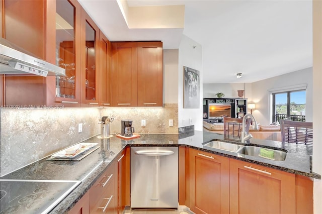 kitchen featuring dark stone counters, ventilation hood, sink, stainless steel dishwasher, and cooktop