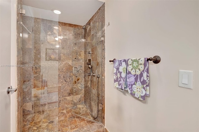 bathroom with a shower with shower door