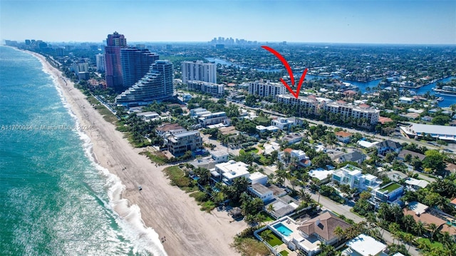 bird's eye view featuring a water view and a beach view