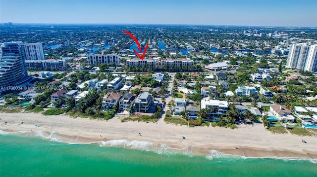 bird's eye view featuring a view of the beach and a water view