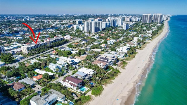 birds eye view of property with a water view and a view of the beach