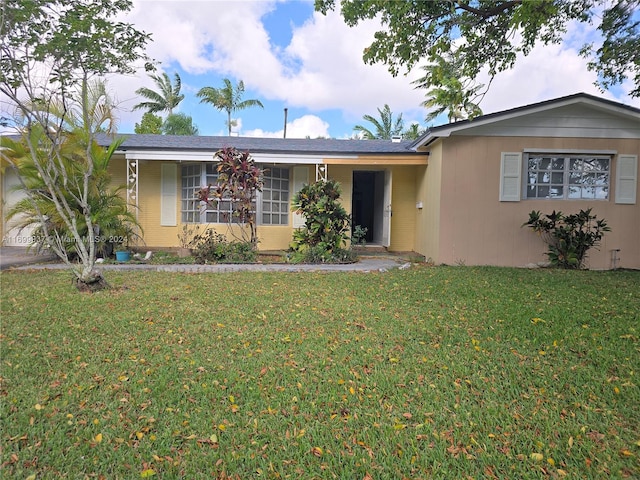 ranch-style home with a front lawn