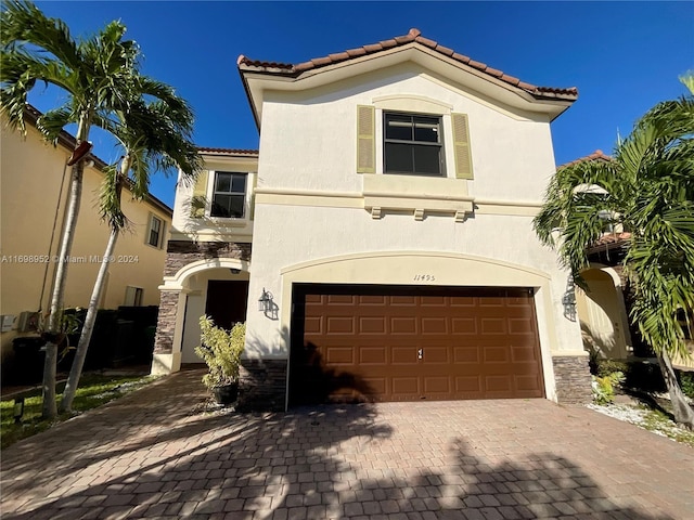 mediterranean / spanish-style home featuring a garage