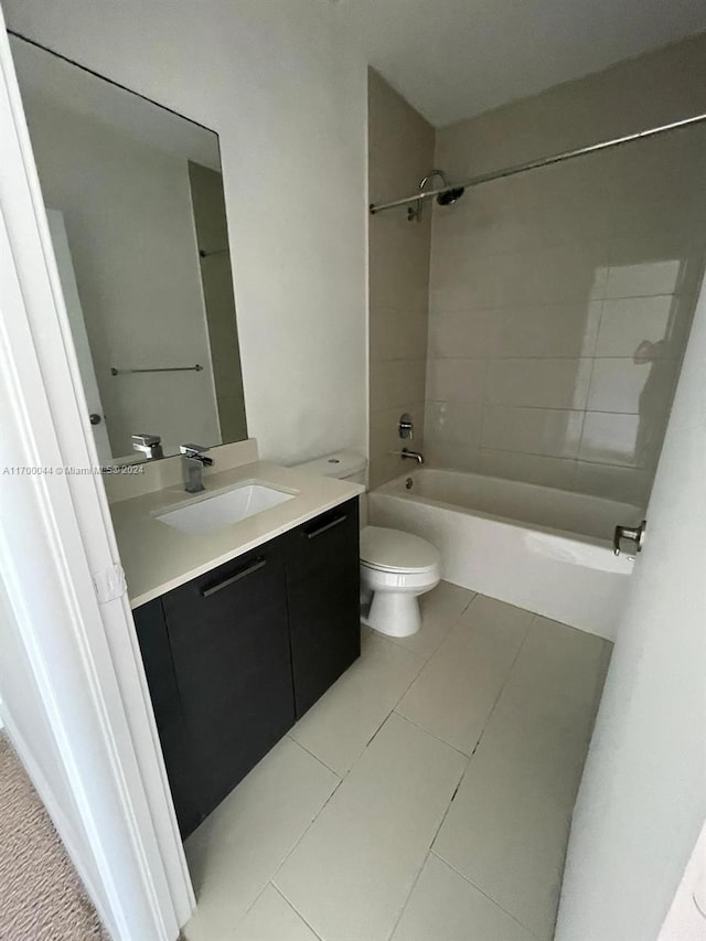 full bathroom with tile patterned flooring, vanity, toilet, and tiled shower / bath