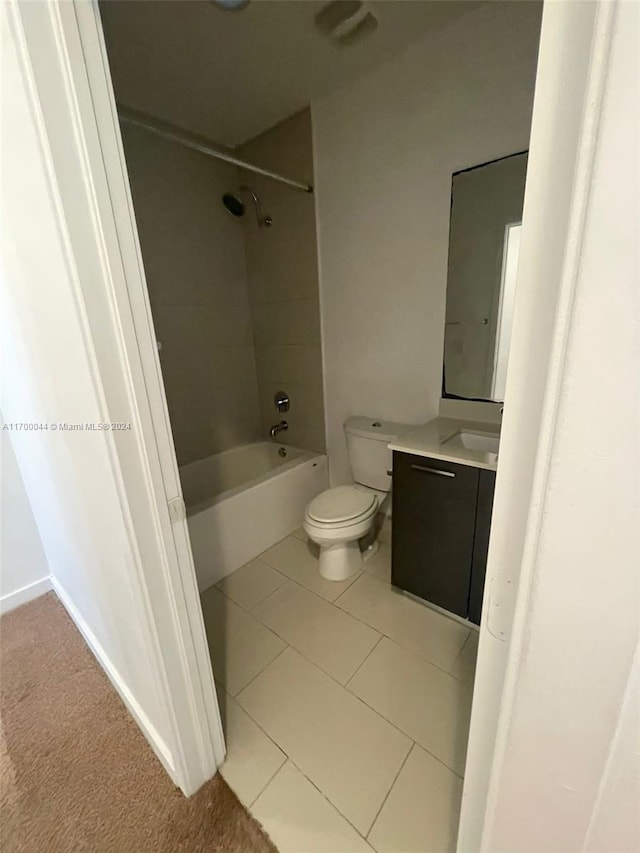 full bathroom with toilet, vanity, tile patterned floors, and tiled shower / bath