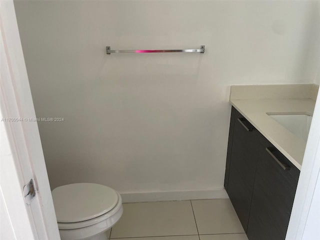 bathroom featuring toilet, vanity, and tile patterned floors