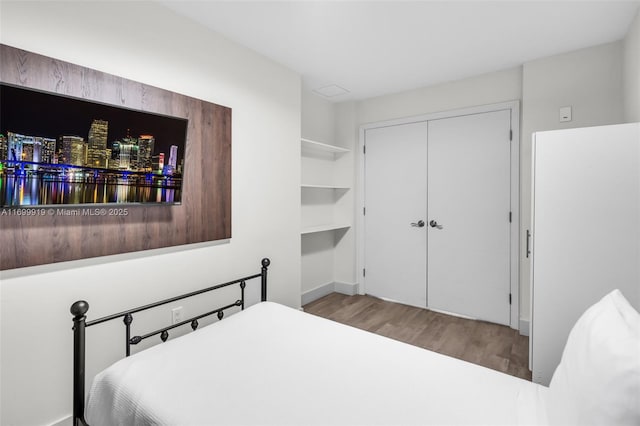 bedroom featuring light wood-type flooring and a closet