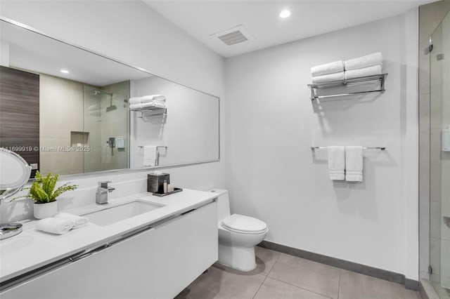 bathroom with vanity, a shower with shower door, toilet, and tile patterned flooring