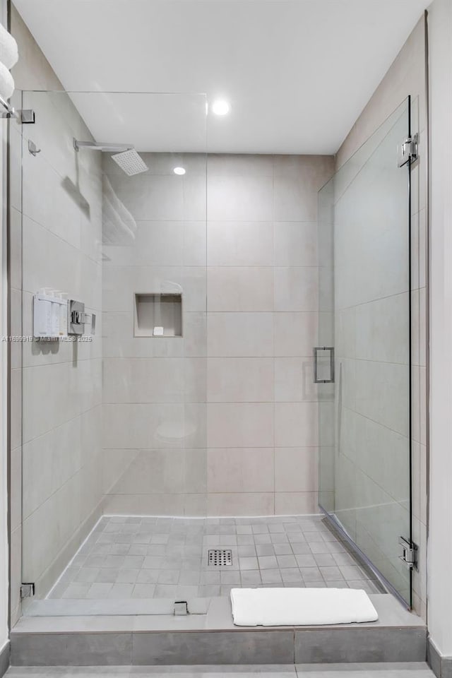 bathroom with a shower with door