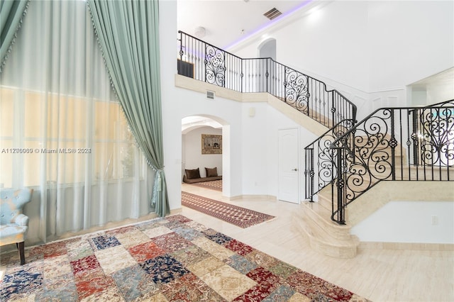 foyer entrance featuring a towering ceiling