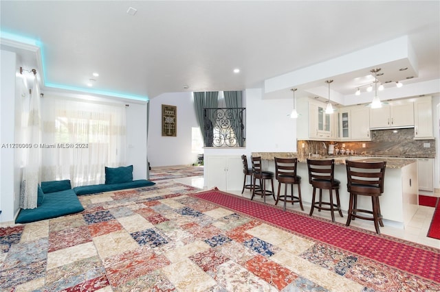 tiled living room with a raised ceiling