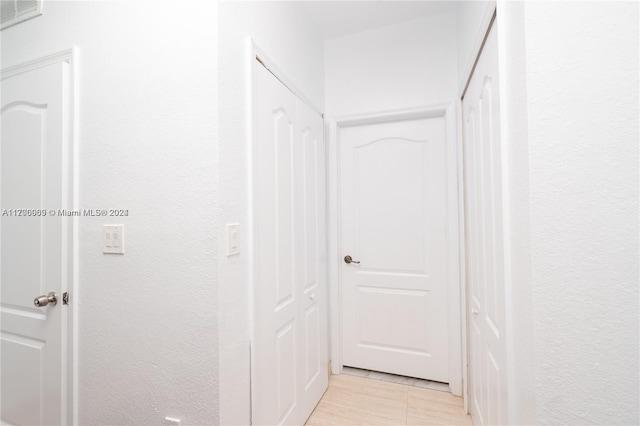 corridor with light tile patterned floors