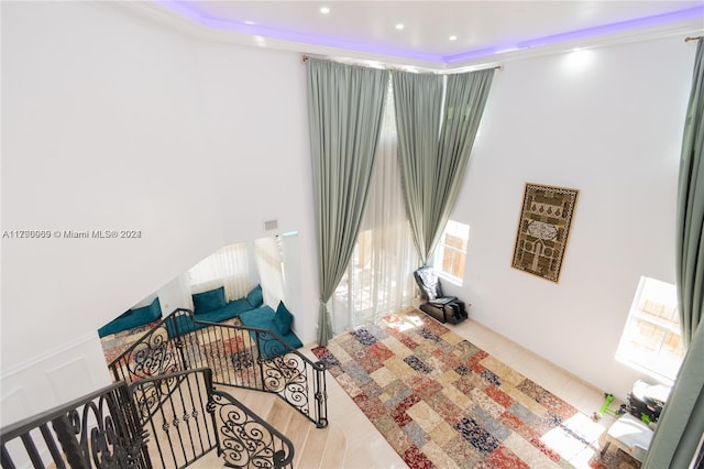 sitting room featuring wood-type flooring and ornamental molding