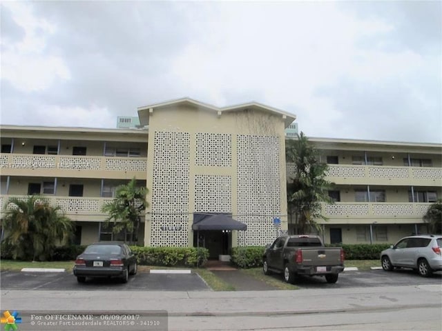 11960 NE 19th Dr Unit 24, North Miami, FL 33181 - view of building exterior with uncovered parking