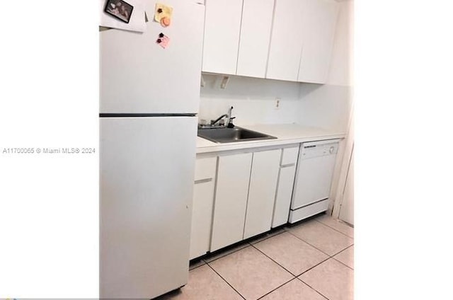 11960 NE 19th Dr Unit 24, North Miami, FL 33181 - kitchen featuring white appliances, light countertops, white cabinets, and light tile patterned flooring