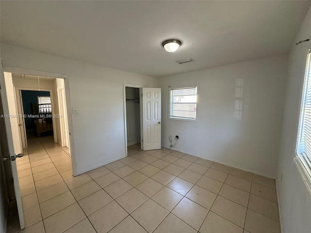 unfurnished bedroom featuring a closet and light tile patterned floors