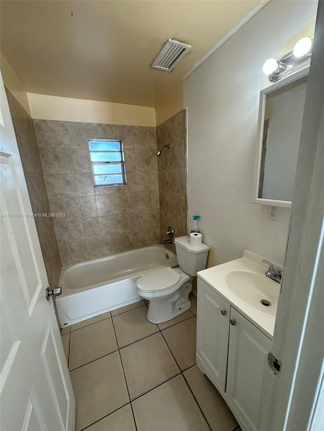 full bathroom featuring tile patterned floors, tiled shower / bath combo, toilet, and vanity