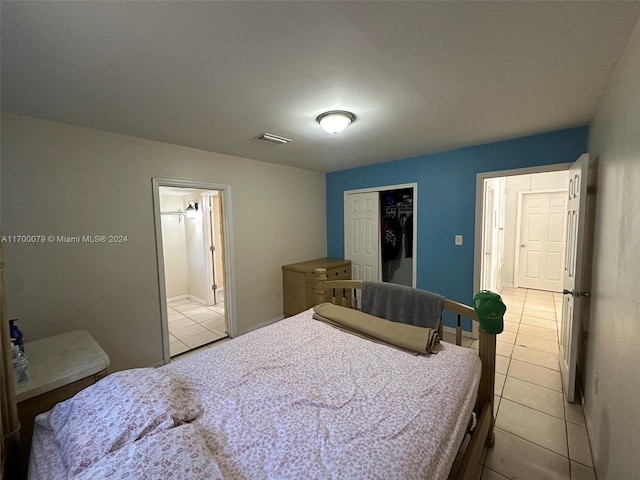 tiled bedroom featuring ensuite bath and a closet