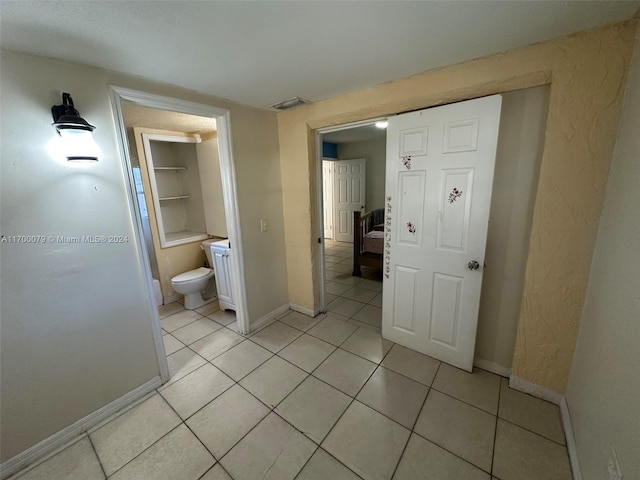 bathroom featuring toilet and tile patterned floors