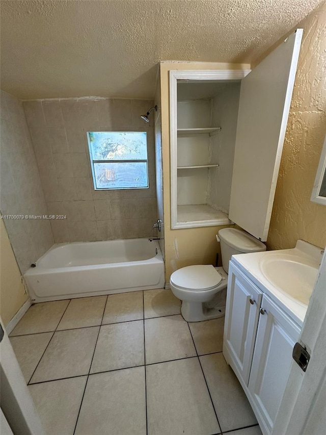 full bathroom featuring tile patterned flooring, vanity, toilet, and a textured ceiling