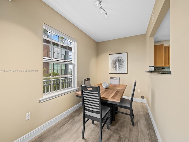 dining space with light hardwood / wood-style flooring