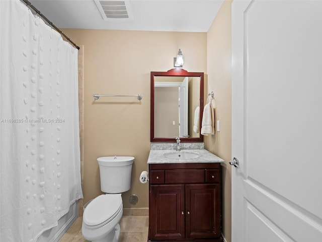 bathroom with tile patterned flooring, vanity, and toilet