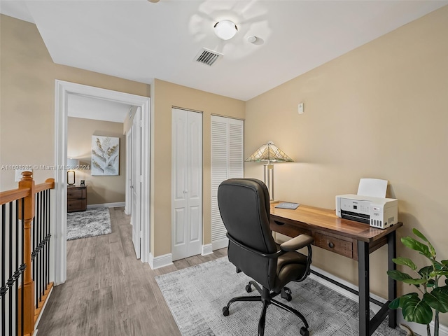 office space with light wood-type flooring