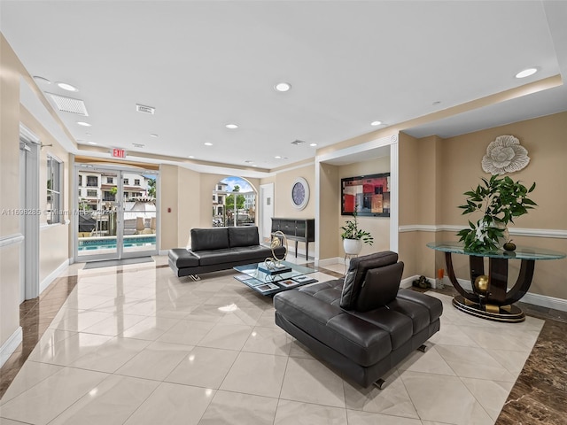 tiled living room featuring french doors