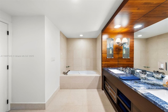 6799 Collins Ave Unit 1704, Miami Beach, FL 33141 - bathroom with a garden tub, double vanity, tile patterned floors, recessed lighting, and baseboards